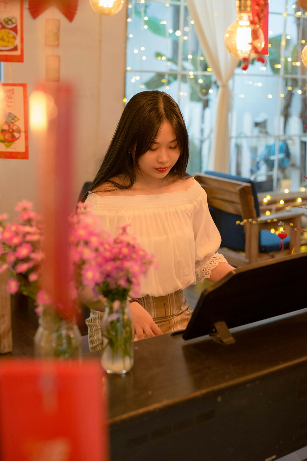 Malaysian Chinese woman reading notes beside a laptop