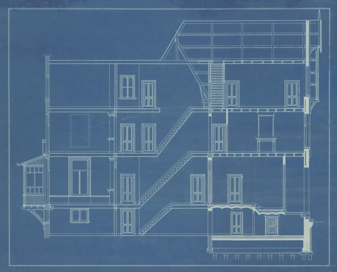 Blueprint style architecture sketch on paper with a pen