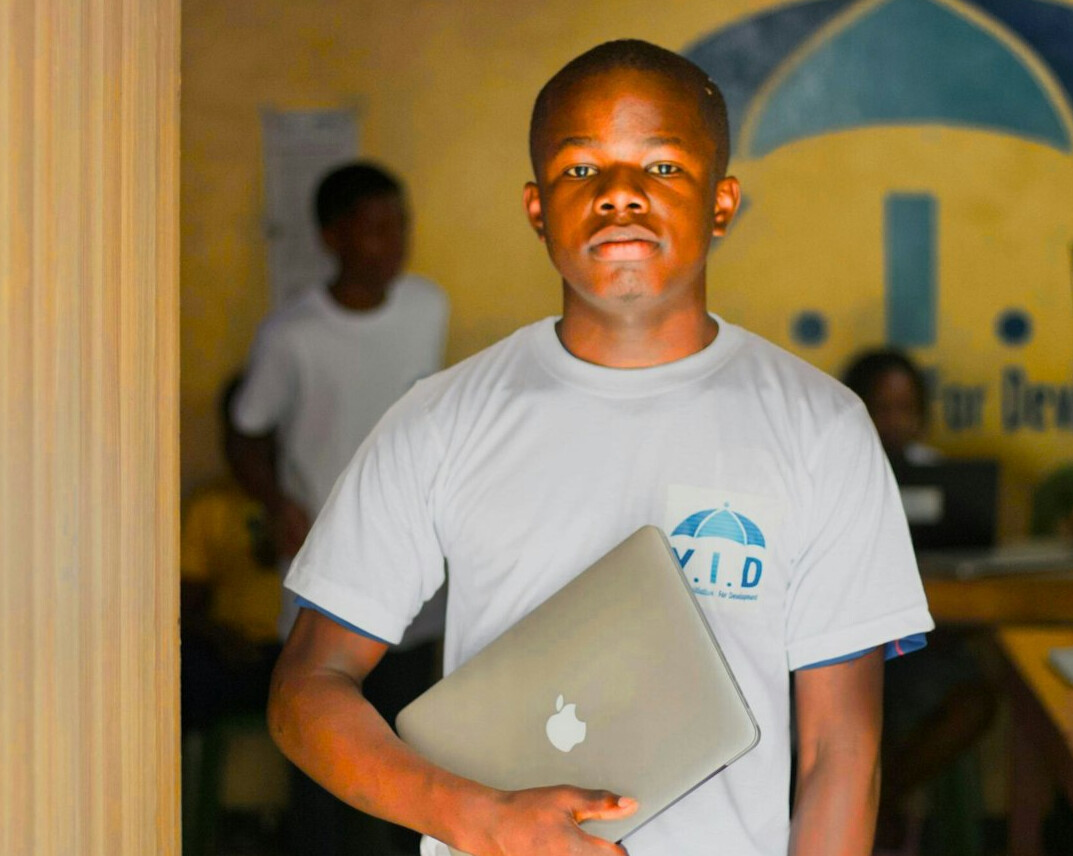 student coding on laptop in classroom