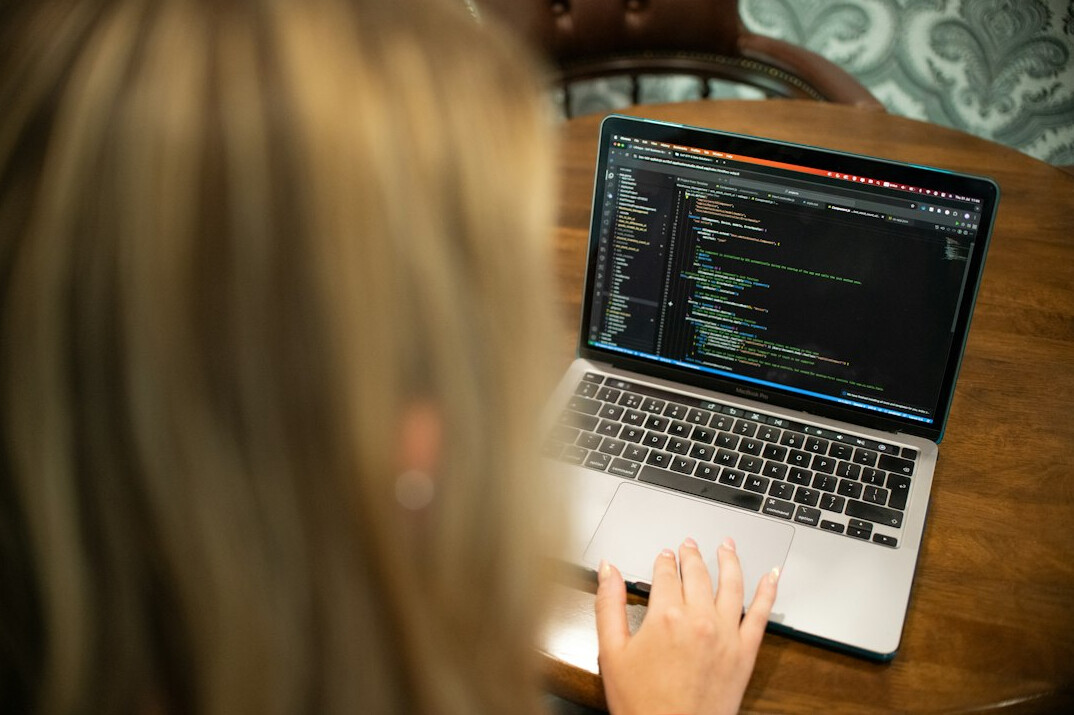 woman coding at laptop